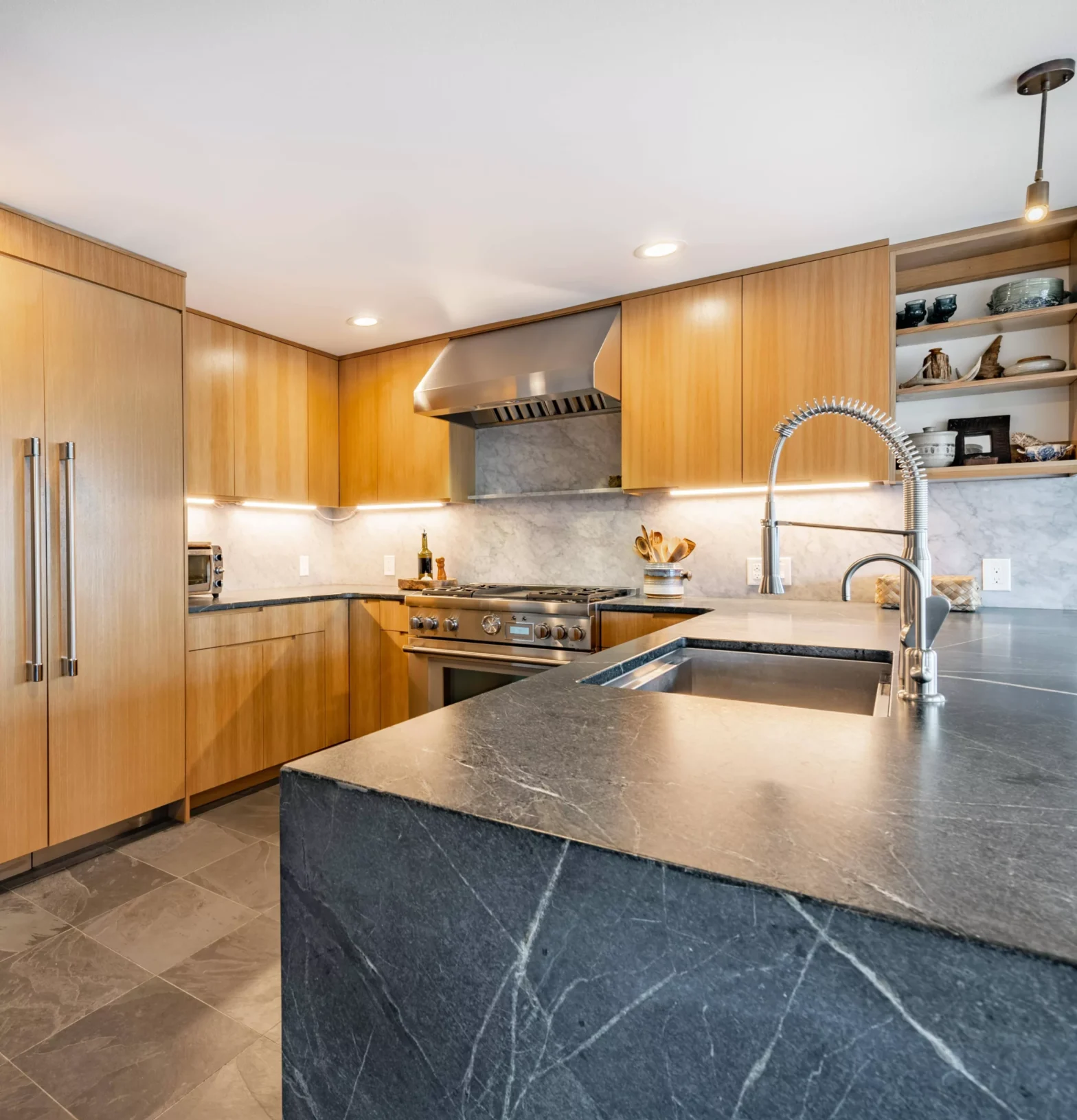 Modern kitchen with black stone island